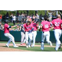 Jake Fraley is mobbed by his Tacoma Rainiers teammates following his game-winning hit